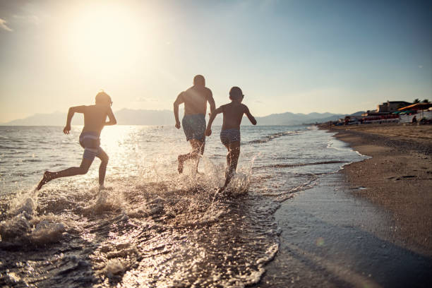 istock Senior man running on the beach with grandsons 2150336460