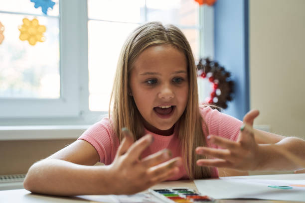 istock Merry girl having fun during art lesson 2150338222
