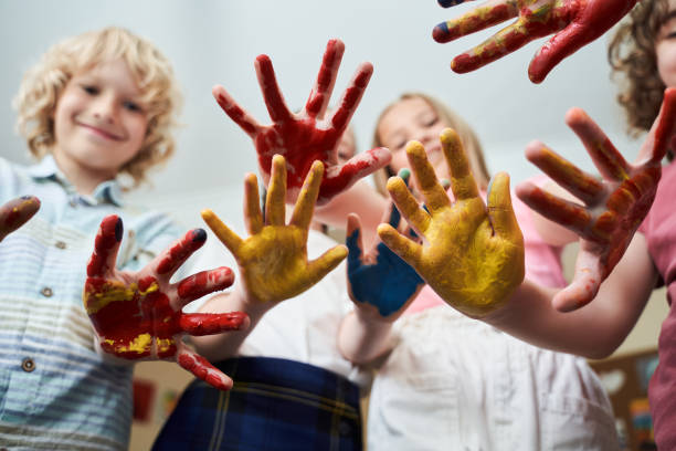 istock Happy kids with hands in colour together 2150338229