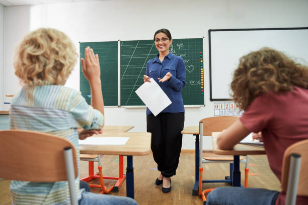 istock Happy teacher enjoying studies with cute boys 2150338279