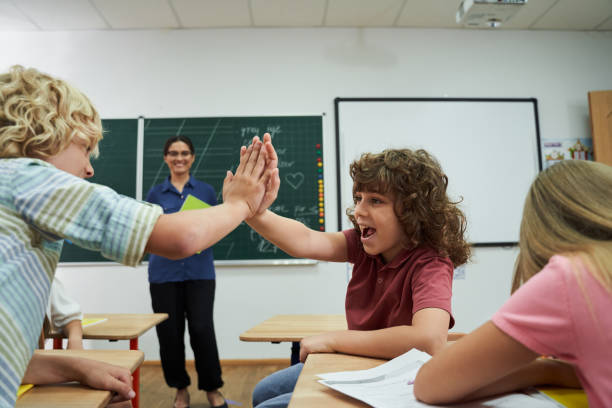 istock Happy pupils enjoying lesson in class room 2150338296