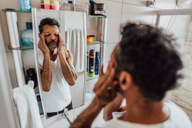 istock Mature man touching on face in the bathroom at home 2150338416