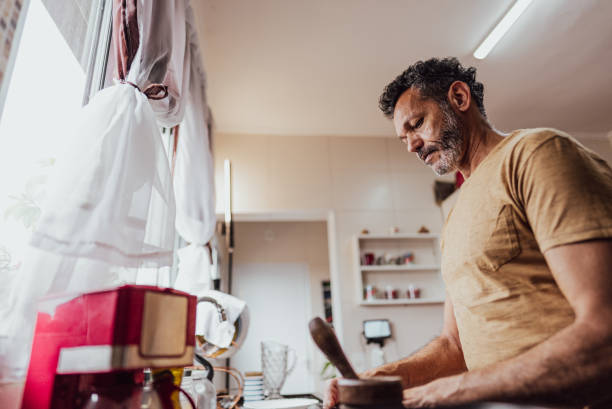 istock Mature man cooking at home 2150338518