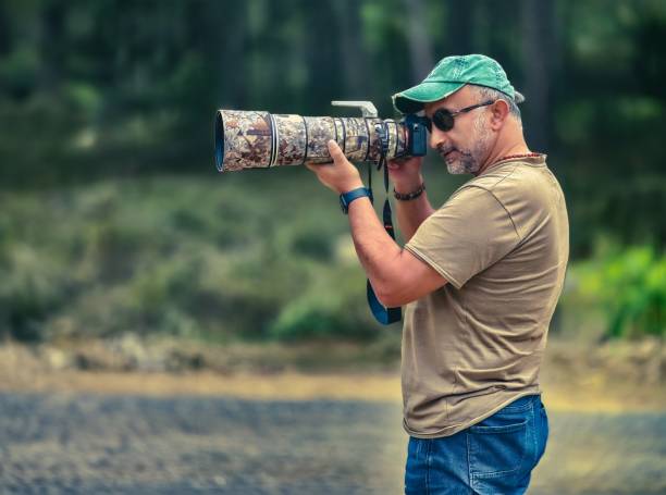 istock A nature photographer photographing birds. 2150340898