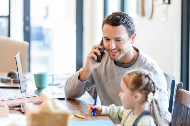 istock Businessman takes a phone call for work at the kitchen table 2150343108