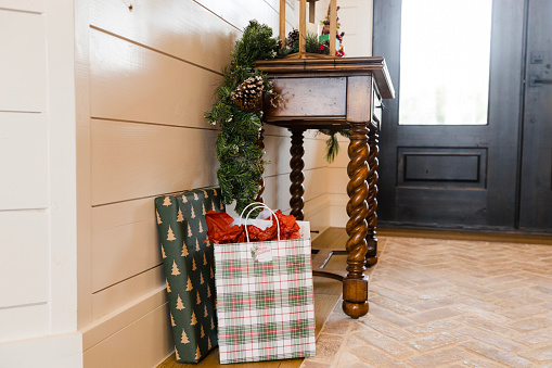 After the family arrived, the Christmas gifts sit on the floor in the entryway of the house.