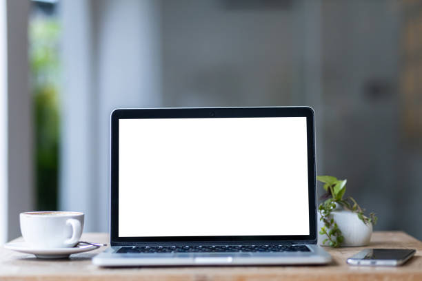 istock Mockup of laptop computer with empty screen with coffee cup and smartphone on table of the coffee shop background,White screen 2150344438