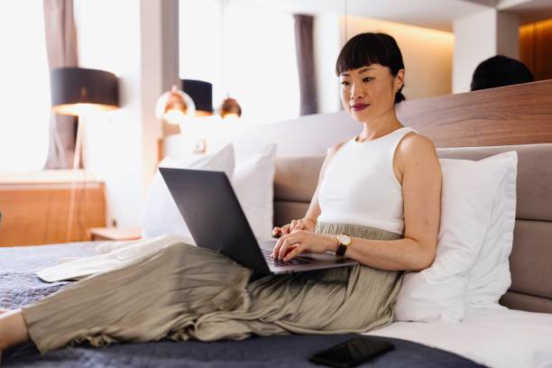 istock Modern businesswoman working from her hotel room 2150345352