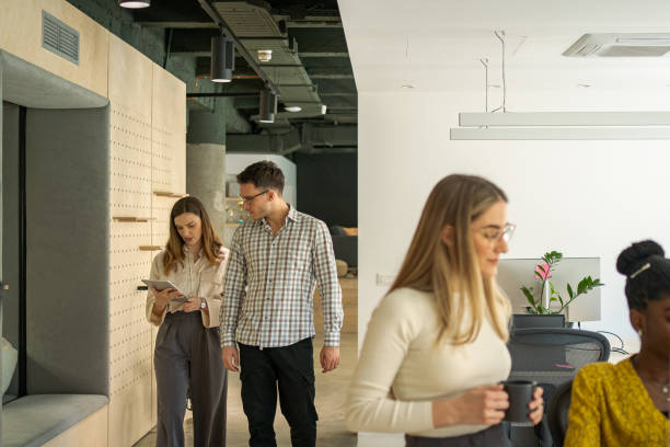 istock Two colleagues at the office are walking and discussing the project. 2150347653