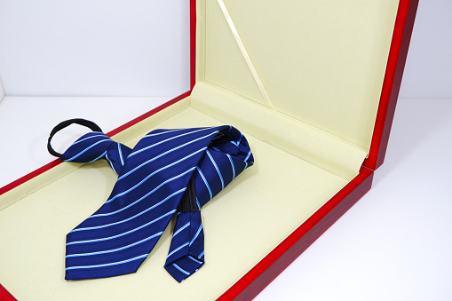 A necktie displayed on gift box close-up view single object