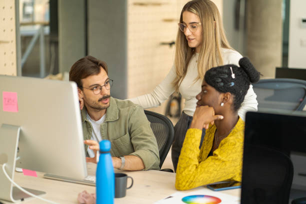 istock Three colleagues are talking about the designer project while looking at the monitor. 2150349202