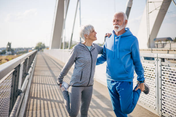 istock Elderly couple is doing warm-up before exercising in nature 2150349278