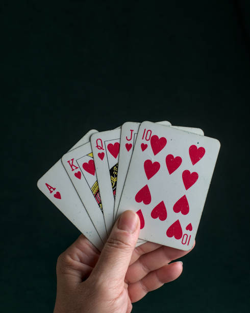 istock a hand holding a poker royal flush 2150350581