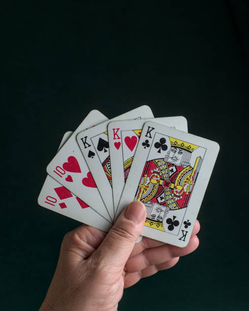 istock a hand holding a poker Full house 2150350585