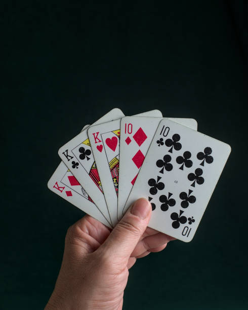 istock a hand holding a poker Full house 2150350587