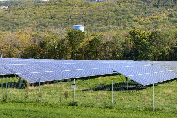 istock Rows of solar panels in a wooded mountain scenery on a sunny fall day 2150351123