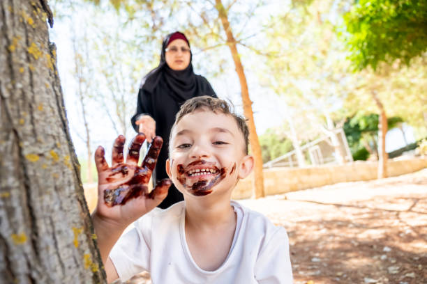 Arabic mother get angry with her son cause s he covered him self with chocolate
