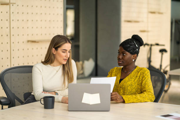 istock Two female colleagues engages in a collaborative discussion about a project, fostering creativity and teamwork. 2150352639