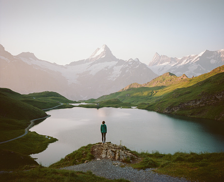 Woman standing near Bachalpsee lake in Swiss Alps. Shot on camera film