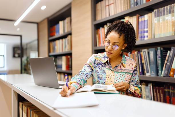 istock Close-up of a professor doing research at the library 2150354592
