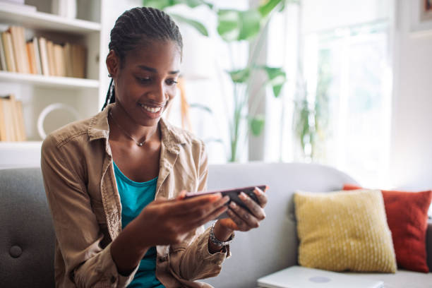 istock Woman reading on smartphone cozy at home 2150355013