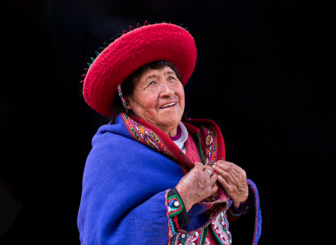Close-up portrait of an indigenous old woman weaver from the Peruvian village of Chinchero looking away with copy space