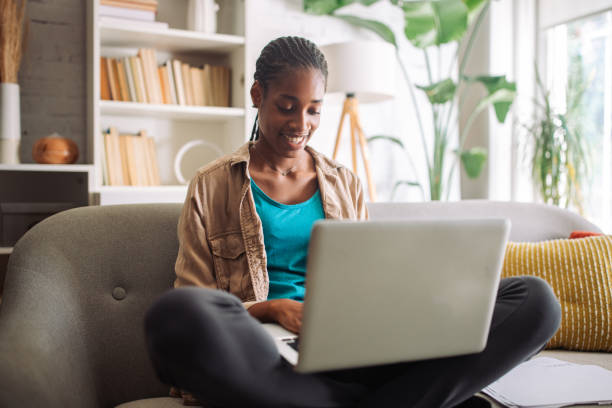 istock Casual black woman working on laptop at home 2150355498