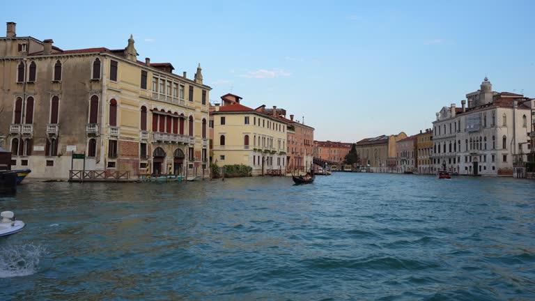 Sailing along wonderful grand canal of Venice surrounded by gondolas and boats. Italy