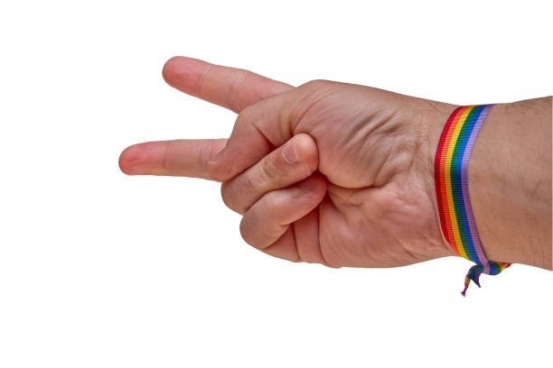 istock Hand making a gun gesture, adorned with a rainbow bracelet, against a white backdrop, symbolizing conflicting messages. 2150355725