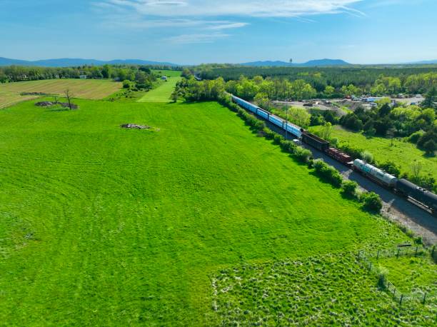 istock Countryside train crossing through a bucolic area 2150356111