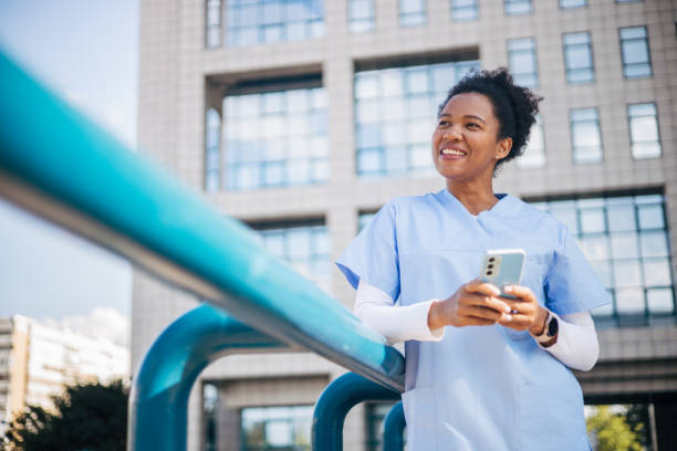 istock Female doctor or nurse browsing on mobile phone 2150358012