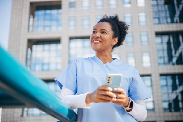 istock Female doctor or nurse browsing on mobile phone 2150358016