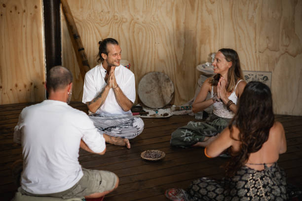 istock Small group of people sitting on the floor meditating 2150358115