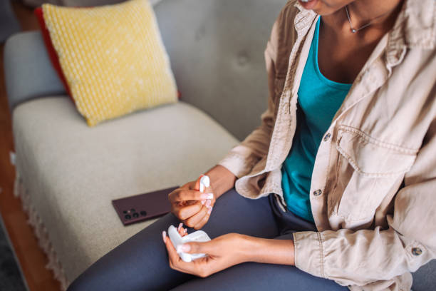 istock Person holding earbuds with a smartphone in background 2150358169