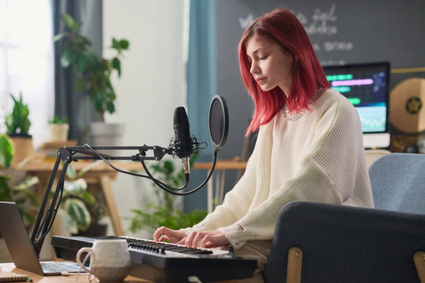 istock Playing synthesizer in front of laptop 2150358480