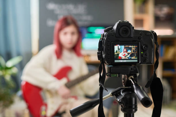 istock Girl with bass guitar on camera screen 2150358494