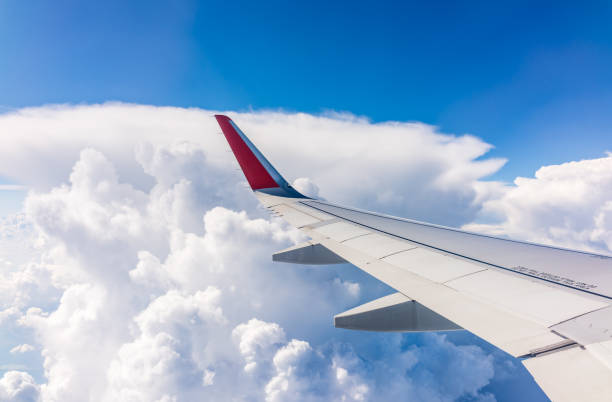 istock View from the airplane window at a beautiful cloudy sky and the airplane wing 2150360664