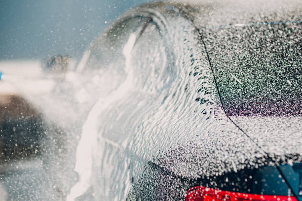 istock Worker washing car at self-service car wash 2150360690