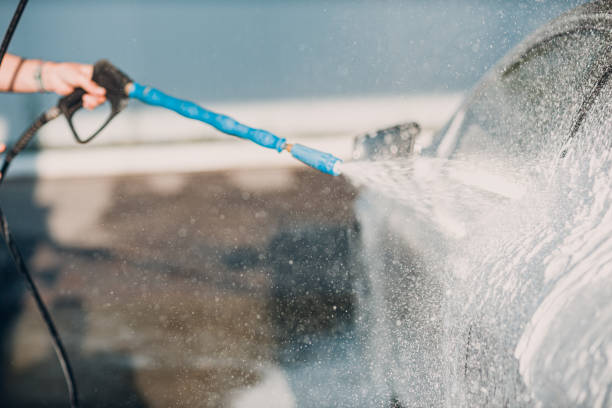 istock Worker washing car at self-service car wash 2150360692