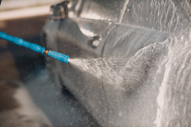 istock Worker washing car at self-service car wash 2150360695