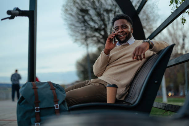 istock Man on a phone call relaxing in park 2150360807