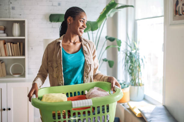 istock Woman carrying a laundry basket 2150361342