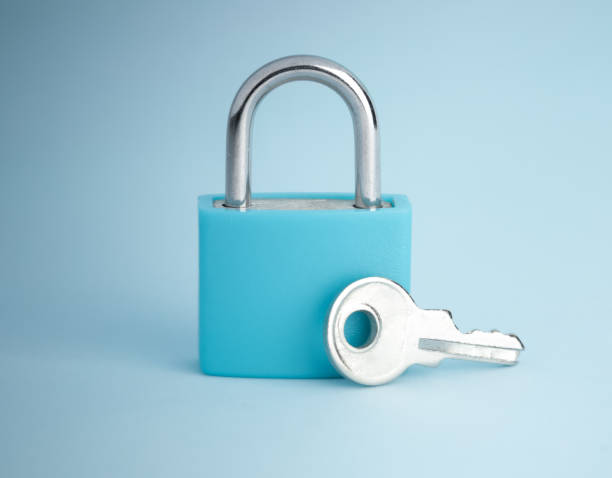 istock Simple lock and key. Small padlock with small shiny key. Business data encryption, home security, or other safeguarding metaphor. 2150361345