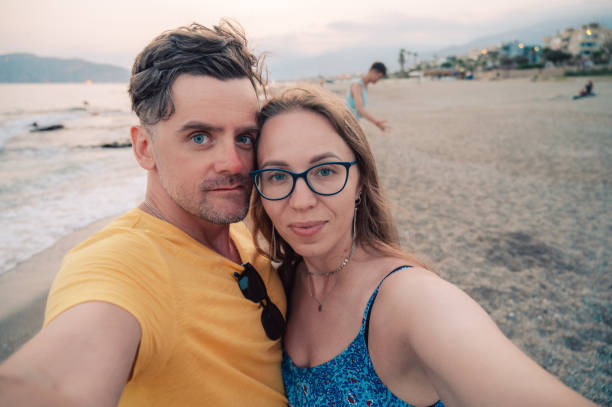 istock Happy couple taking a photo on a beach 2150364457