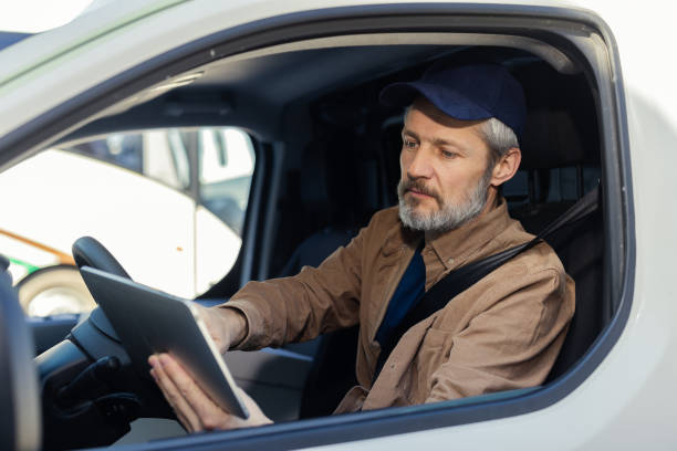 istock Delivery man using tablet  to find the address for delivering 2150364462