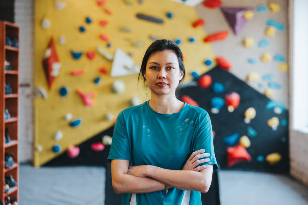 istock Female bouldering instructor in indoors climbing gym 2150364618