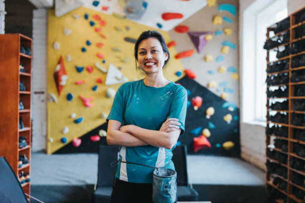 istock Female bouldering instructor in indoors climbing gym 2150364674
