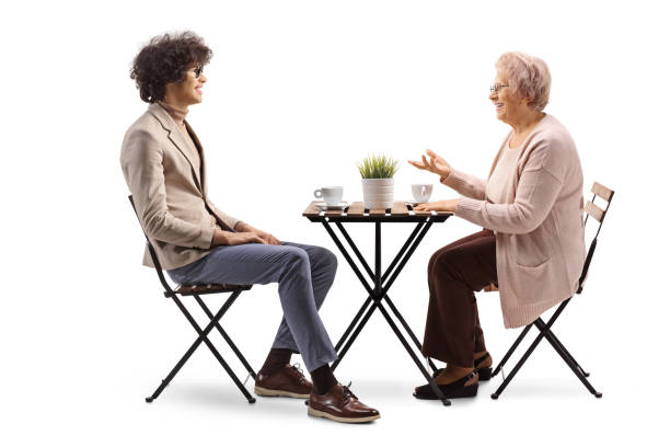 istock Young man and elderly woman having coffee and talking 2150364781