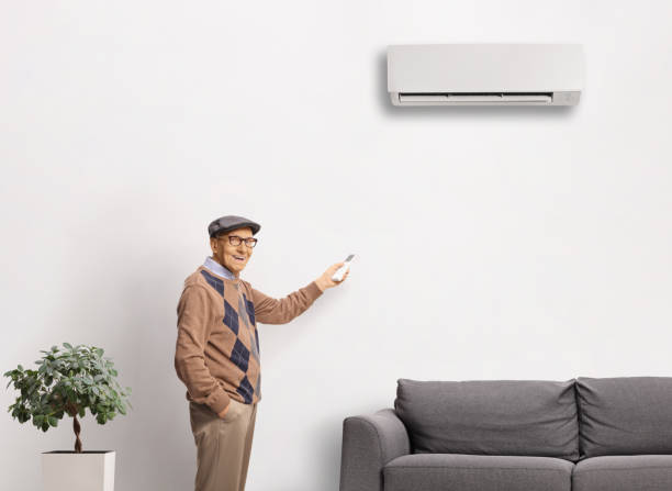 istock Elderly man putting on an air conditioning unit 2150364790