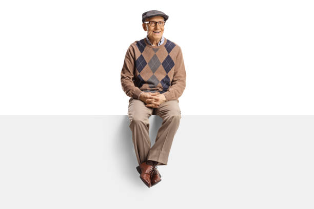 istock Pensioner sitting on a blank panel and looking at camera 2150365181